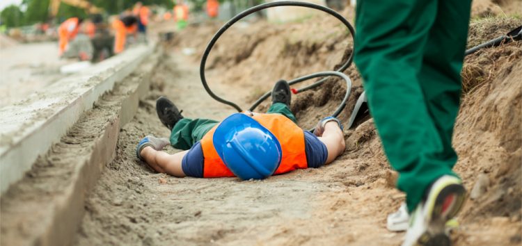construction worker lying unconscious after an accident at work
