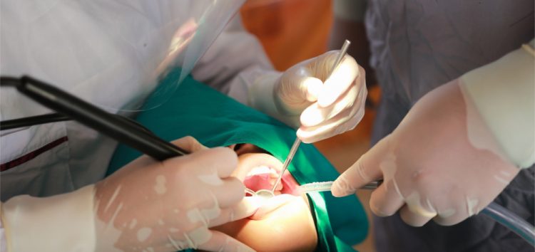 Dentist operating on a patients teeth