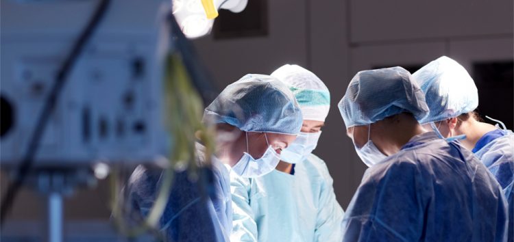 Surgeons in masks operating