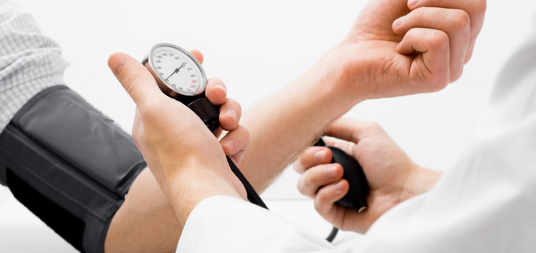 A doctor measuring a patient's blood pressure