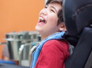 Happy child with cerebral palsy condition