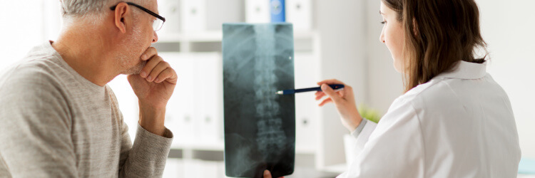 Doctor discussing a spinal X-Ray with a patient