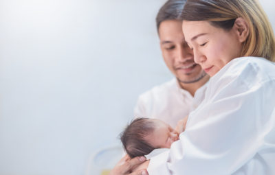 parents holding their newborn bay