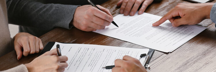 People signing a contract